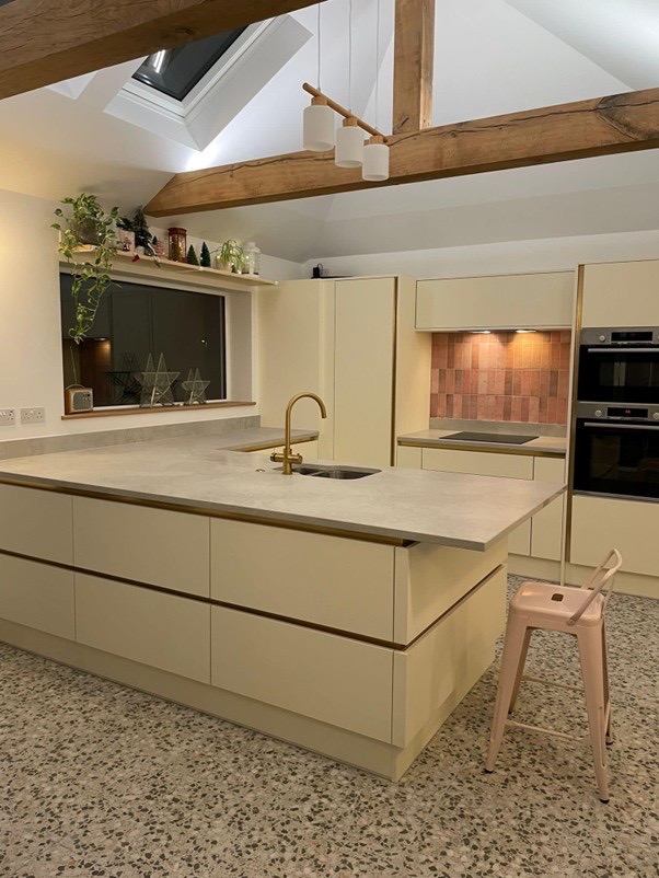 white kitchen with pink tiles in a newly built pitched roof extension