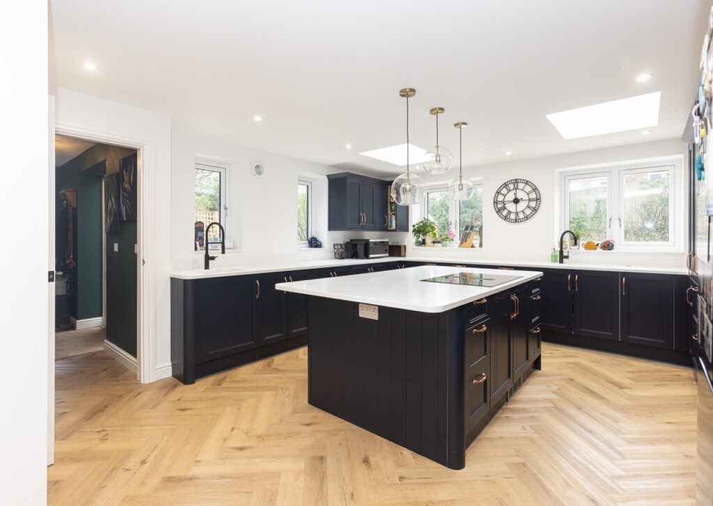 navy kitchen with parquet flooring in a new build extension