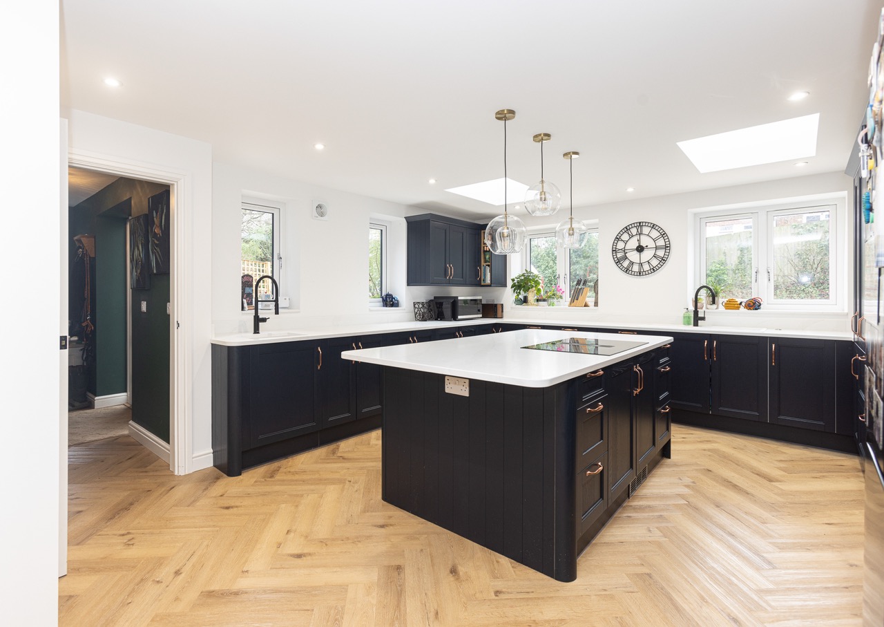 navy kitchen with parquet flooring in a new build extension