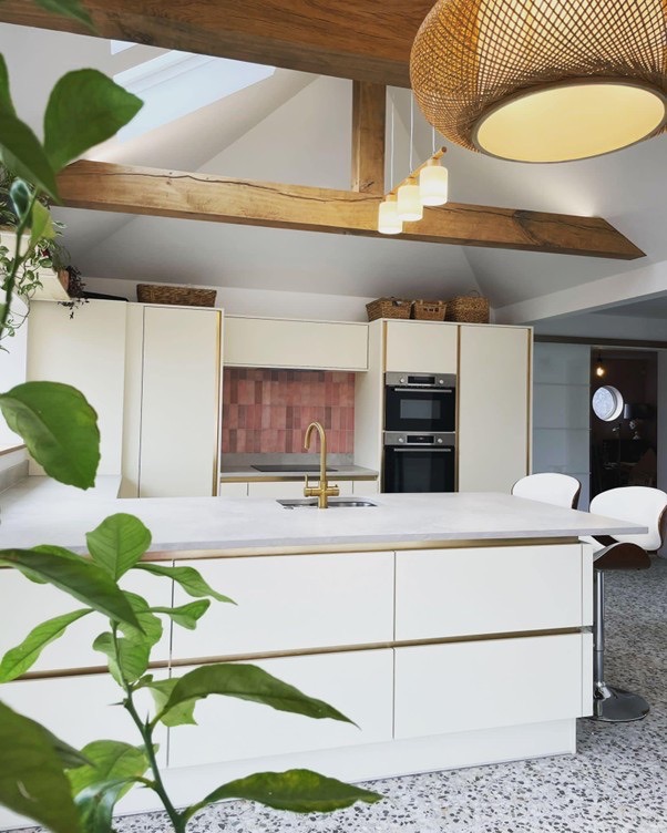 marble kitchen extension with pitched roofs and wooden beams