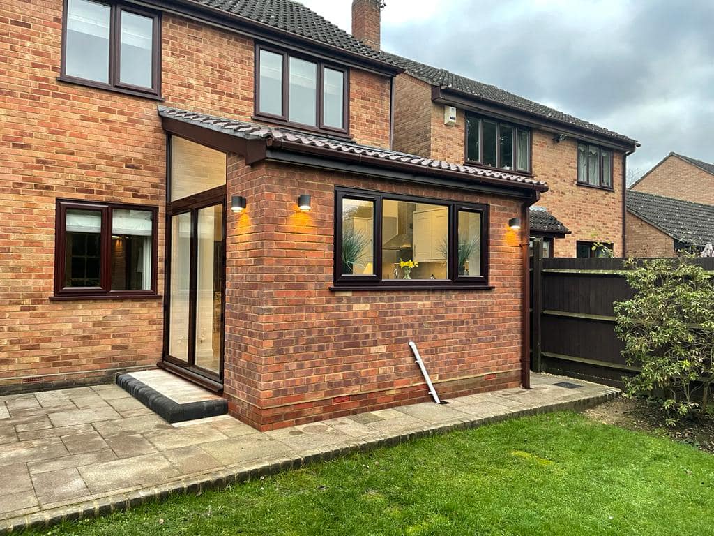 exterior of a lean to brick extension in twyford with mahogany uPVC patio and window frames